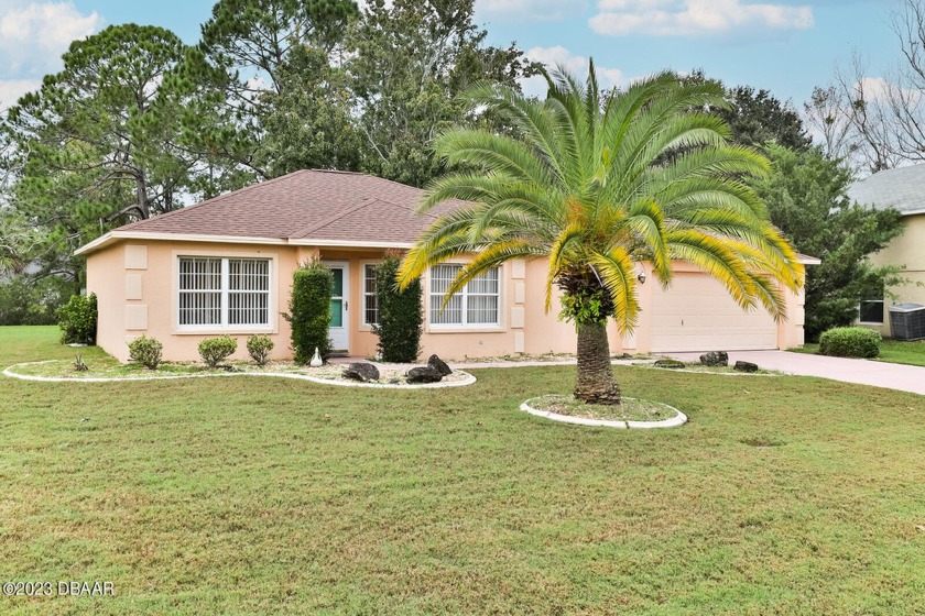 This charming split floor plan home, nestled in the Palm Harbor - Beach Home for sale in Palm Coast, Florida on Beachhouse.com