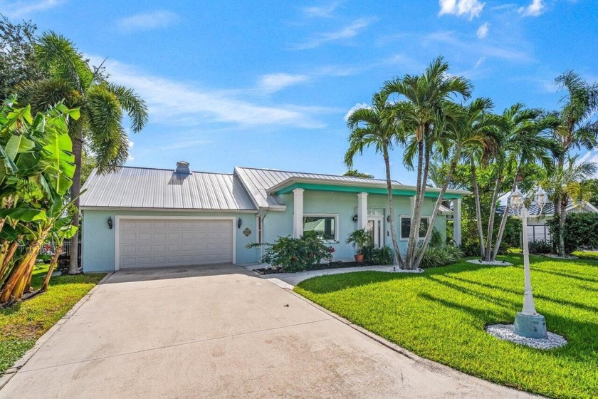 Waterfront living on W Lake Drive in Lake Clarke Shores! This - Beach Home for sale in Lake Clarke Shores, Florida on Beachhouse.com