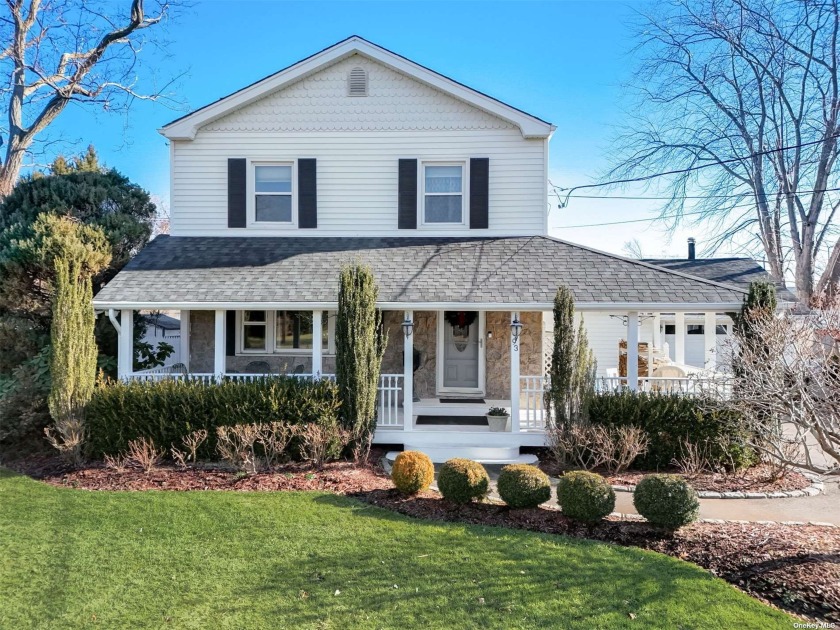 Stunning colonial with wrap-around front porch situated on a - Beach Home for sale in Bay Shore, New York on Beachhouse.com
