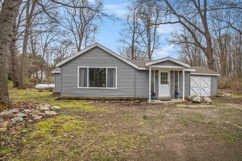 Tucked away on a wooded half-acre, this updated 2-bedroom - Beach Home for sale in Saugatuck, Michigan on Beachhouse.com