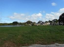 Vacant spacious WATERFRONT LOT ON LAKE no HOA FEES HAVE LAND - Beach Lot for sale in Holiday, Florida on Beachhouse.com