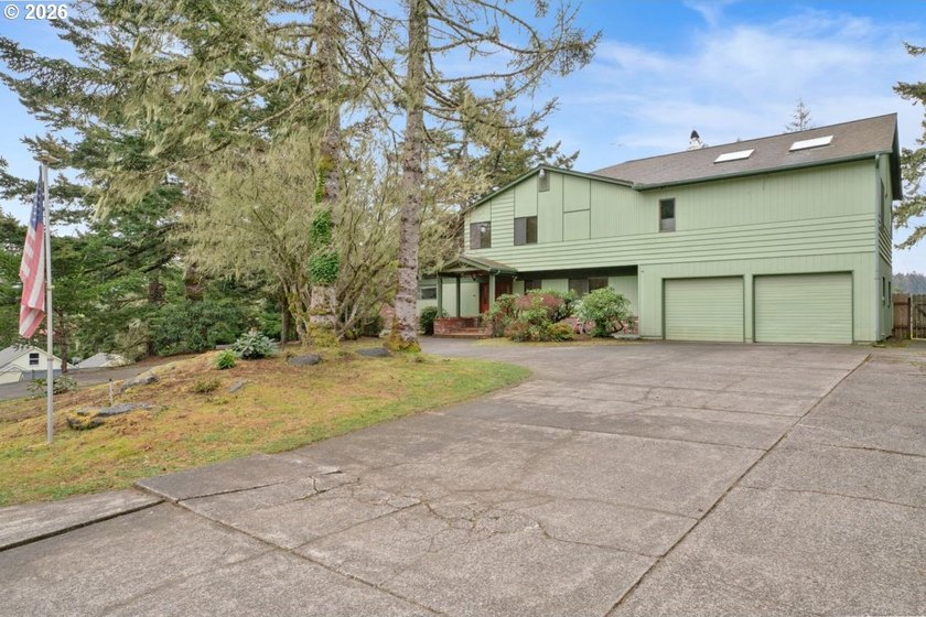 Nestled on 1.03 private acres, this spacious 3-level home offers - Beach Home for sale in Florence, Oregon on Beachhouse.com