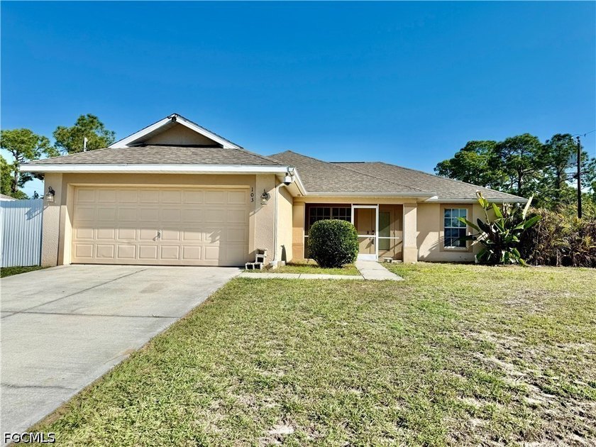 Affordable 3 bedroom 2 bath home with a double garage, FENCED - Beach Home for sale in Lehigh Acres, Florida on Beachhouse.com