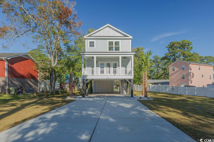 Discover the essence of coastal luxury in this brand-new - Beach Home for sale in Surfside Beach, South Carolina on Beachhouse.com