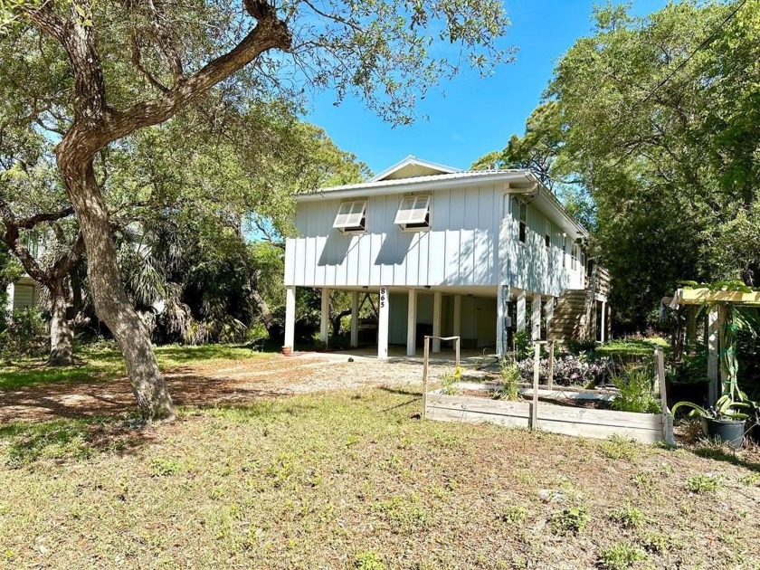 Take a look at this adorable coastal cottage- nestled perfectly - Beach Home for sale in St. George Island, Florida on Beachhouse.com