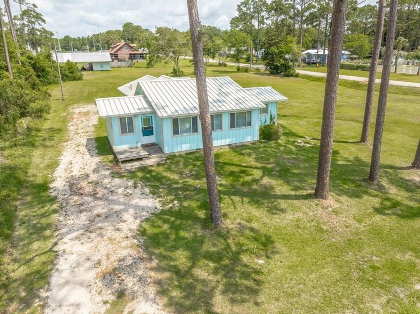 Soak in the sun and salty breeze from this charming Bayfront - Beach Home for sale in Eastpoint, Florida on Beachhouse.com