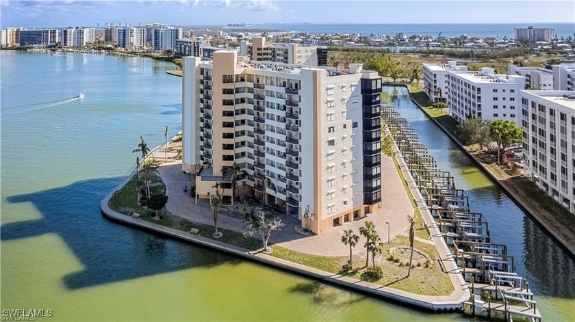 BRAND NEW BOAT SLIP and 10,000 lb lift INCLUDED with this - Beach Condo for sale in Fort Myers Beach, Florida on Beachhouse.com