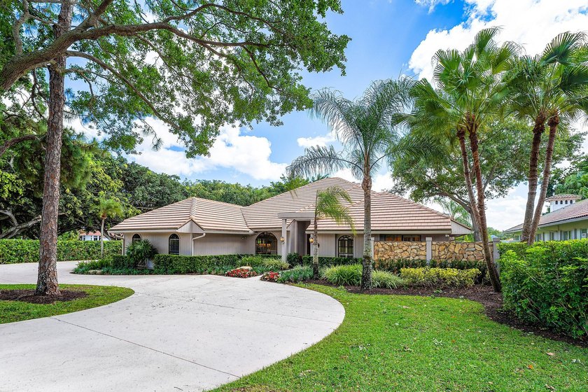 Set on an exceptionally private half-acre corner lot at the end - Beach Home for sale in Palm Beach Gardens, Florida on Beachhouse.com