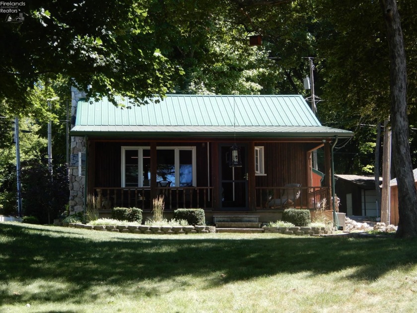 This Island gem of a log cabin on the coveted West Shore has - Beach Home for sale in Put-In-Bay, Ohio on Beachhouse.com