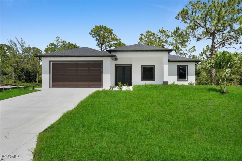 Experience modern living on a spacious half-acre lot, with the - Beach Home for sale in Lehigh Acres, Florida on Beachhouse.com