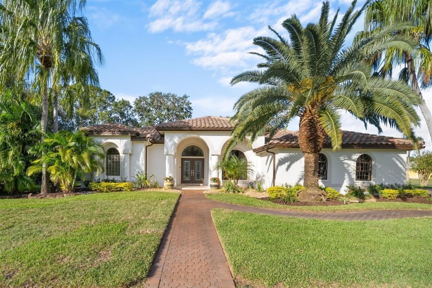 Welcome to this stunning home, nestled on a spacious  1/2 + acre - Beach Home for sale in Tarpon Springs, Florida on Beachhouse.com