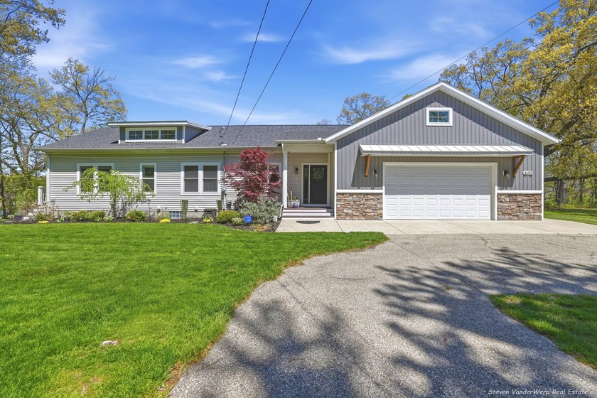Enjoy waterfront living with 128 feet of frontage on Lloyds - Beach Home for sale in Spring Lake, Michigan on Beachhouse.com