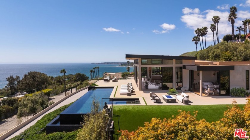 Privately set behind a gated driveway, this exceptional estate - Beach Home for sale in Malibu, California on Beachhouse.com