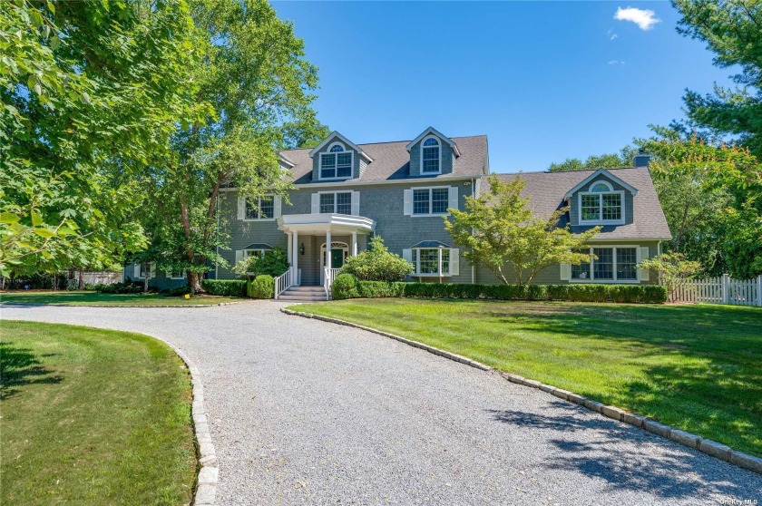 Welcome to 4 Hidden Pond Lane, this impressive home is set back - Beach Home for sale in Westhampton, New York on Beachhouse.com