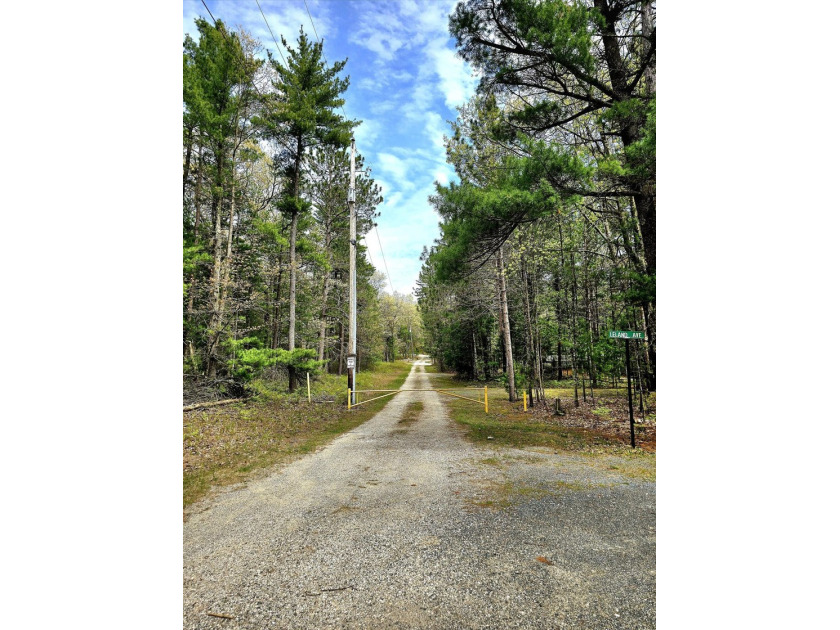 Nestled on a quiet private drive, this exceptional vacant lot - Beach Acreage for sale in Pentwater, Michigan on Beachhouse.com