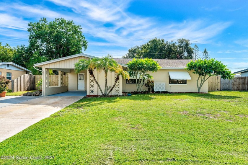 Welcome to this charming Mid-Century Modern home nestled in the - Beach Home for sale in Merritt Island, Florida on Beachhouse.com