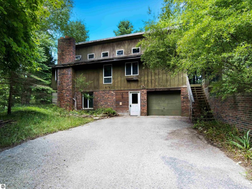 Discover the potential in this charming fixer-upper nestled on a - Beach Home for sale in Frankfort, Michigan on Beachhouse.com