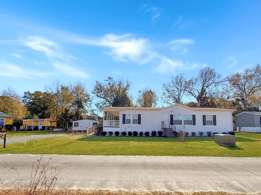 Nestled on a spacious quarter-acre lot just a short distance - Beach Home for sale in Wewahitchka, Florida on Beachhouse.com