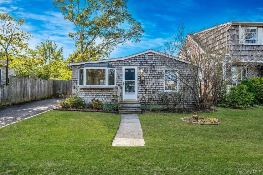 Nestled beside the shimmering serenity of Lake Shore Drive, 56 - Beach Home for sale in Patchogue, New York on Beachhouse.com