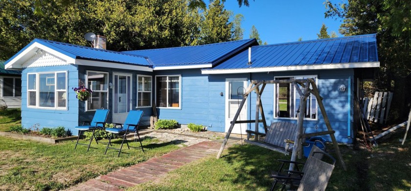 Enjoy unforgettable sunsets from this 2BR/1BA lakefront cottage - Beach Home for sale in Hessel, Michigan on Beachhouse.com