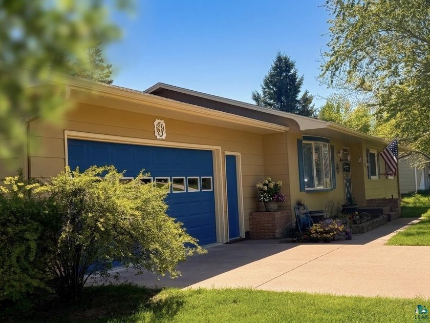 Nestled on a beautifully manicured lot with mature trees, this - Beach Home for sale in Washburn, Wisconsin on Beachhouse.com