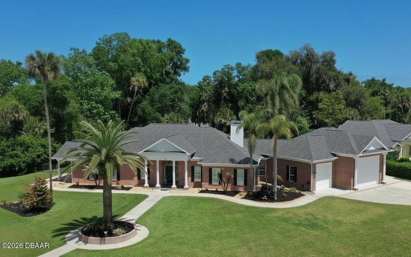 This distinguished brick residence, set beneath a canopy of - Beach Home for sale in Ormond Beach, Florida on Beachhouse.com
