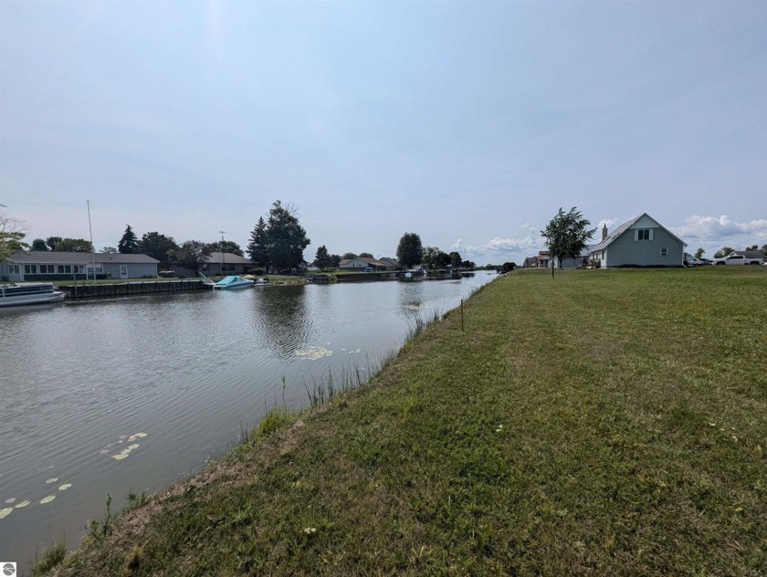 Enjoy nearly 150' of frontage along a canal leading out to Lake - Beach Lot for sale in Au Gres, Michigan on Beachhouse.com