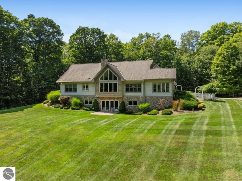 Nestled on a private 40-acre wooded parcel, this stunning home - Beach Home for sale in Charlevoix, Michigan on Beachhouse.com