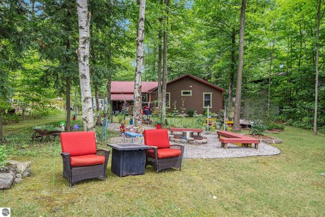 Nestled in the desirable Sugarloaf Chalets, this cute home is a - Beach Home for sale in Cedar, Michigan on Beachhouse.com