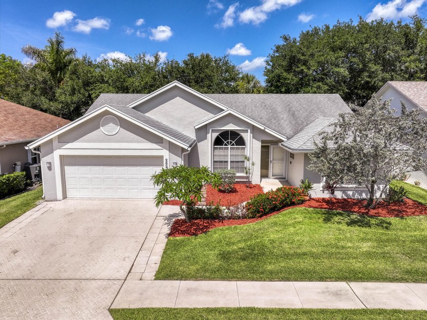 Manicured landscaping and soaring vaulted ceilings welcome you - Beach Home for sale in Jupiter, Florida on Beachhouse.com