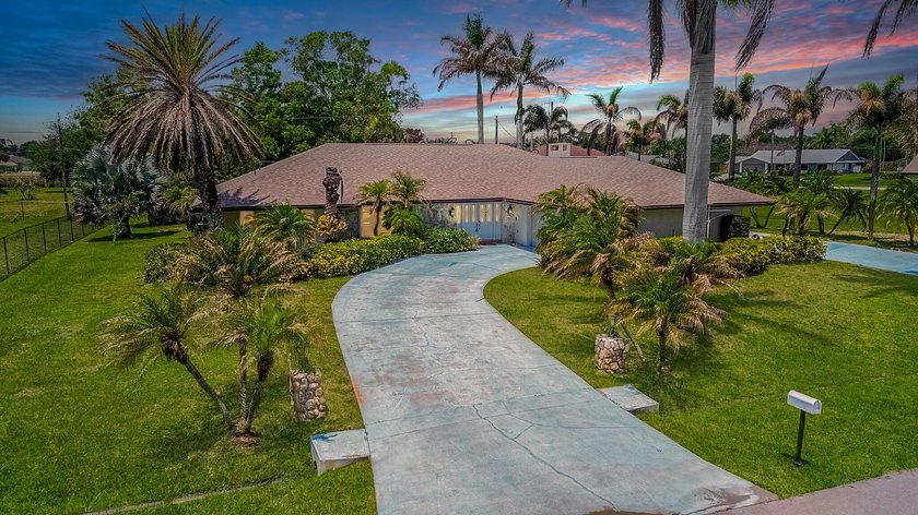 Tropical living awaits in desirable Sandpiper Bay! Situated on - Beach Home for sale in Port Saint Lucie, Florida on Beachhouse.com