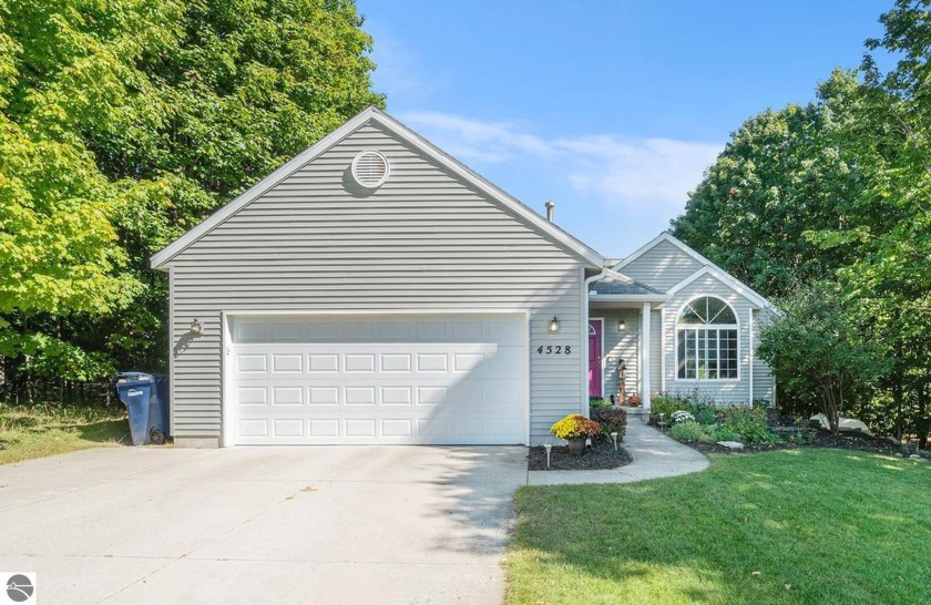 Stunning quad-level home nestled on a serene 1-acre partially - Beach Home for sale in Traverse City, Michigan on Beachhouse.com