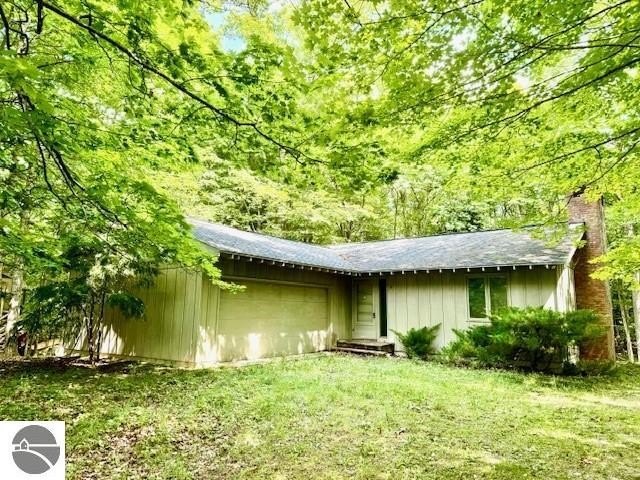 This house is set amongst mature trees that create a sense of - Beach Home for sale in Leland, Michigan on Beachhouse.com