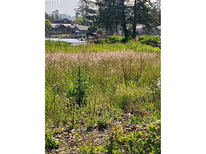 Discover a prime 0.45-acre canal-front lot in the serene Lake - Beach Lot for sale in Lincoln City, Oregon on Beachhouse.com