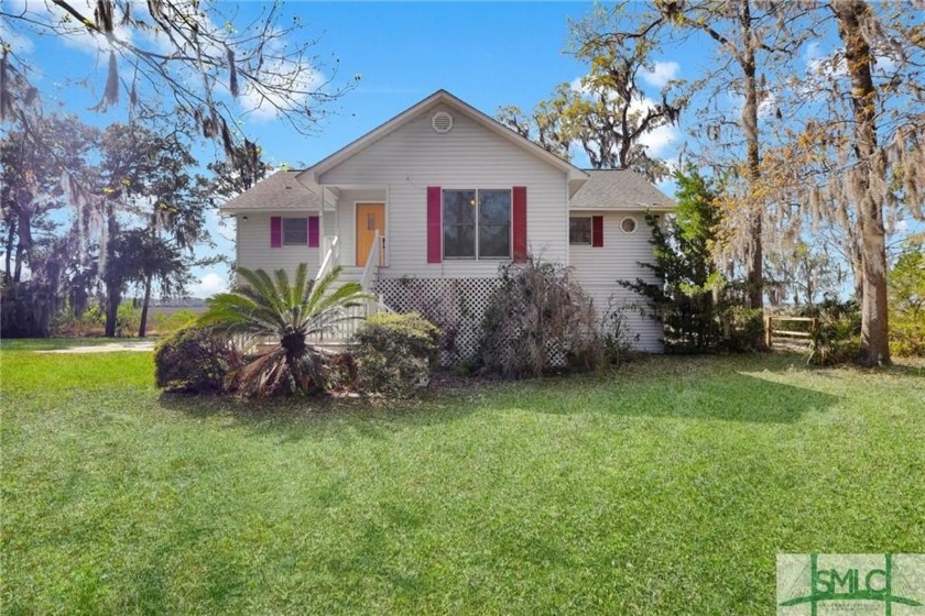 Nestled along the Medway River, this elevated Lowcountry home - Beach Home for sale in Midway, Georgia on Beachhouse.com