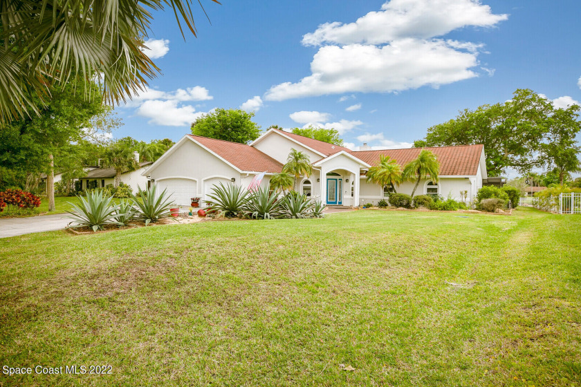 This beautiful canal home boasts 5 bedrooms, an office, 3 full - Beach Home for sale in Merritt Island, Florida on Beachhouse.com