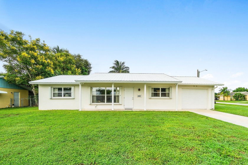 Welcome to this bright 3-bedroom, 2-bath home with a 1-car - Beach Home for sale in Palm Beach Gardens, Florida on Beachhouse.com