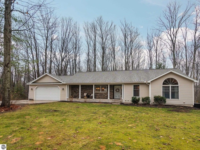 Situated on a wooded corner lot at the end of a quiet cul-de-sac - Beach Home for sale in Traverse City, Michigan on Beachhouse.com