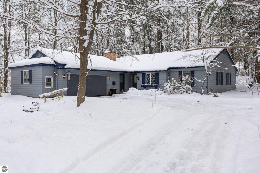 Nestled in a serene and private setting, this charming 3-bedroom - Beach Home for sale in Traverse City, Michigan on Beachhouse.com