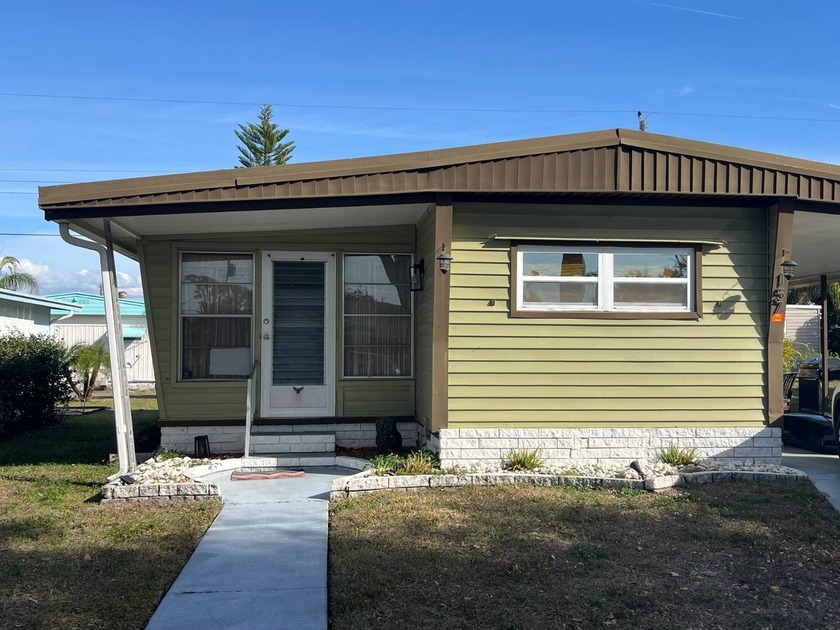 This charming singlewide home with an addition offers 2 bedrooms - Beach Home for sale in Dunedin, Florida on Beachhouse.com