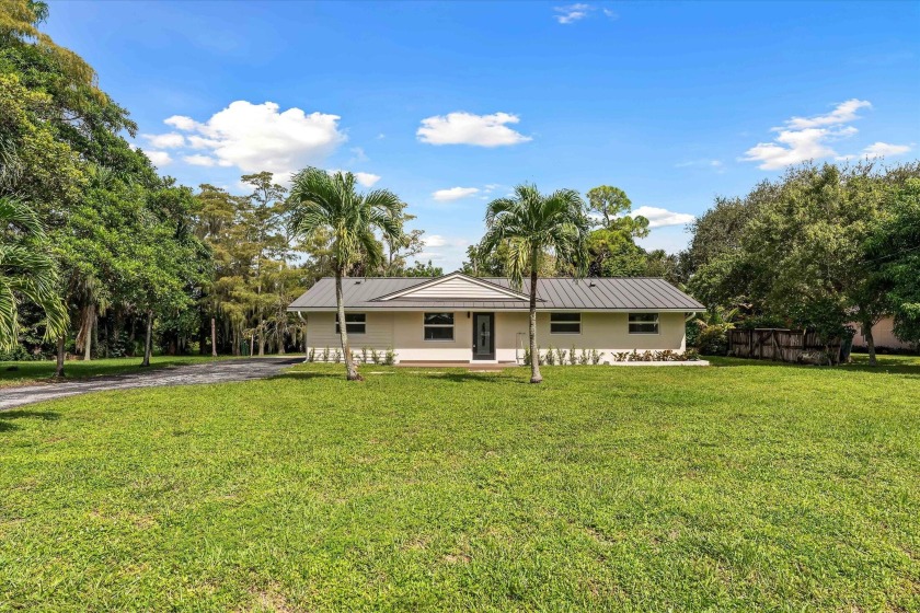 Discover this completely renovated 4-bedroom, 2-bath home on - Beach Home for sale in Palm Beach Gardens, Florida on Beachhouse.com