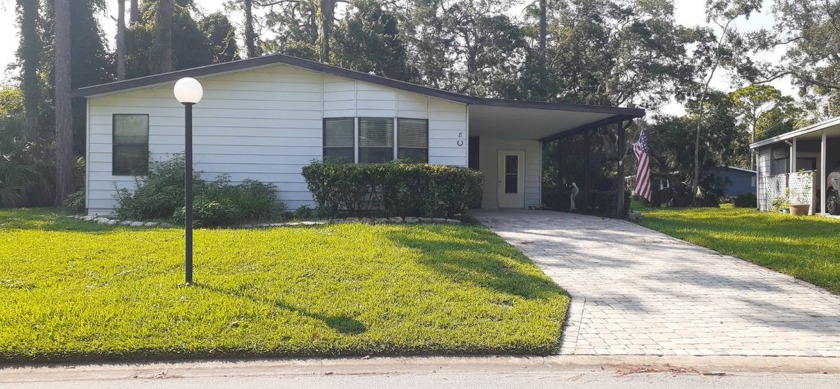 Nestled among the oak trees you will love this lakefront home - Beach Home for sale in Ormond Beach, Florida on Beachhouse.com