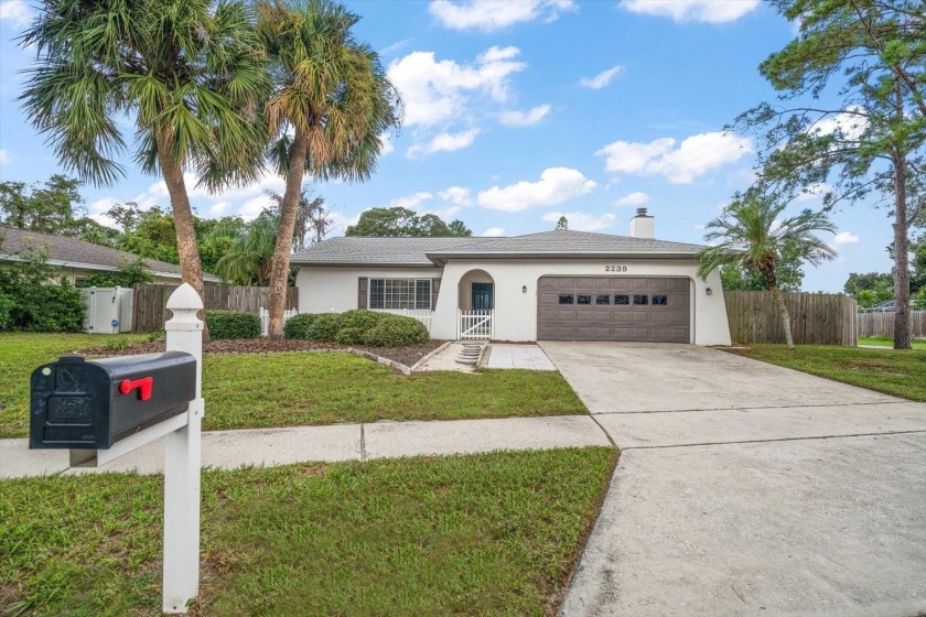 Welcome to this delightful single-family home tucked away in the - Beach Home for sale in Palm Harbor, Florida on Beachhouse.com