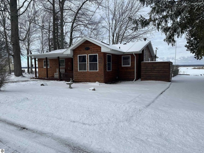 Escape to this idyllic  Tawas lakefront log home boasting 3 - Beach Home for sale in East Tawas, Michigan on Beachhouse.com