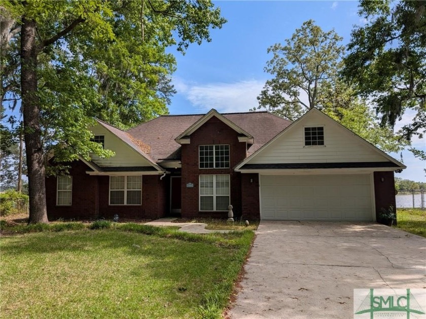 INVESTOR SPECIAL! Lakefront 3 BR/2 BA brick home located on Lake - Beach Home for sale in Midway, Georgia on Beachhouse.com