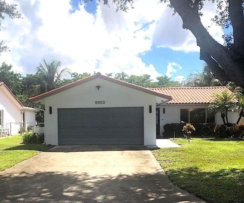Step into this stunning single-family residence featuring an - Beach Home for sale in Coral Springs, Florida on Beachhouse.com