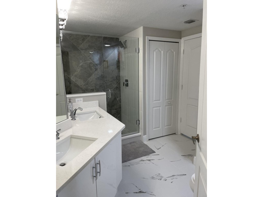 This Condo was remodeled in 2022. The Bathroom has a frameless - Beach Condo for sale in Palm Beach Gardens, Florida on Beachhouse.com