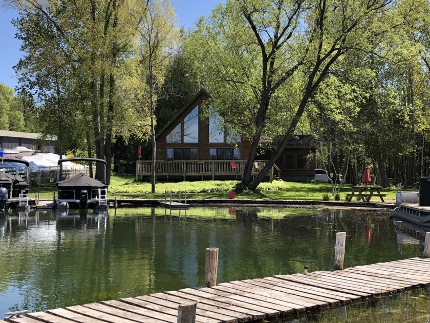 Beautiful log sided, Chalet style home on the Crooked River - Beach Home for sale in Alanson, Michigan on Beachhouse.com