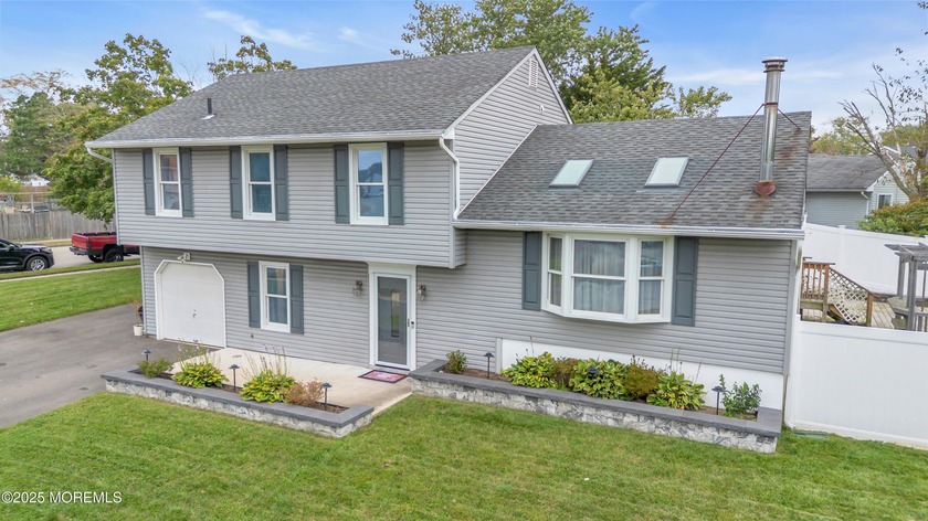 This inviting 4-bedroom, 2.5-bath split-level home sits on a - Beach Home for sale in Barnegat, New Jersey on Beachhouse.com