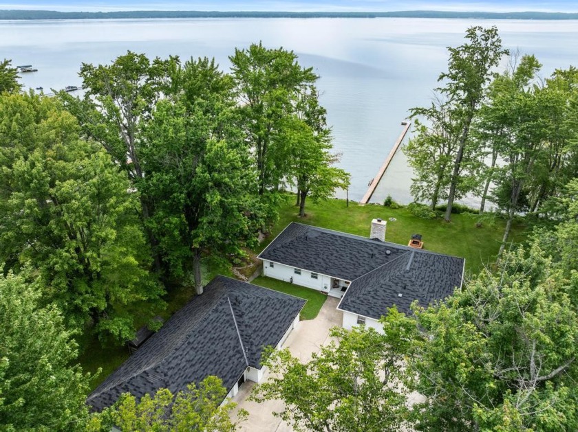 Located on the west shore of Burt Lake on 245 ft of frontage and - Beach Home for sale in Brutus, Michigan on Beachhouse.com